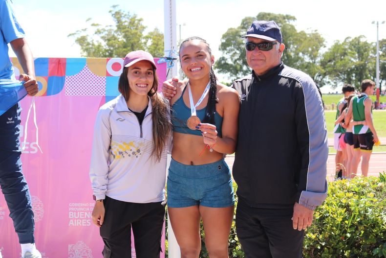 Roberto Vitale acompañando a la atleta juvenil Morena Pugin al obtener la medalla en salto en largo.